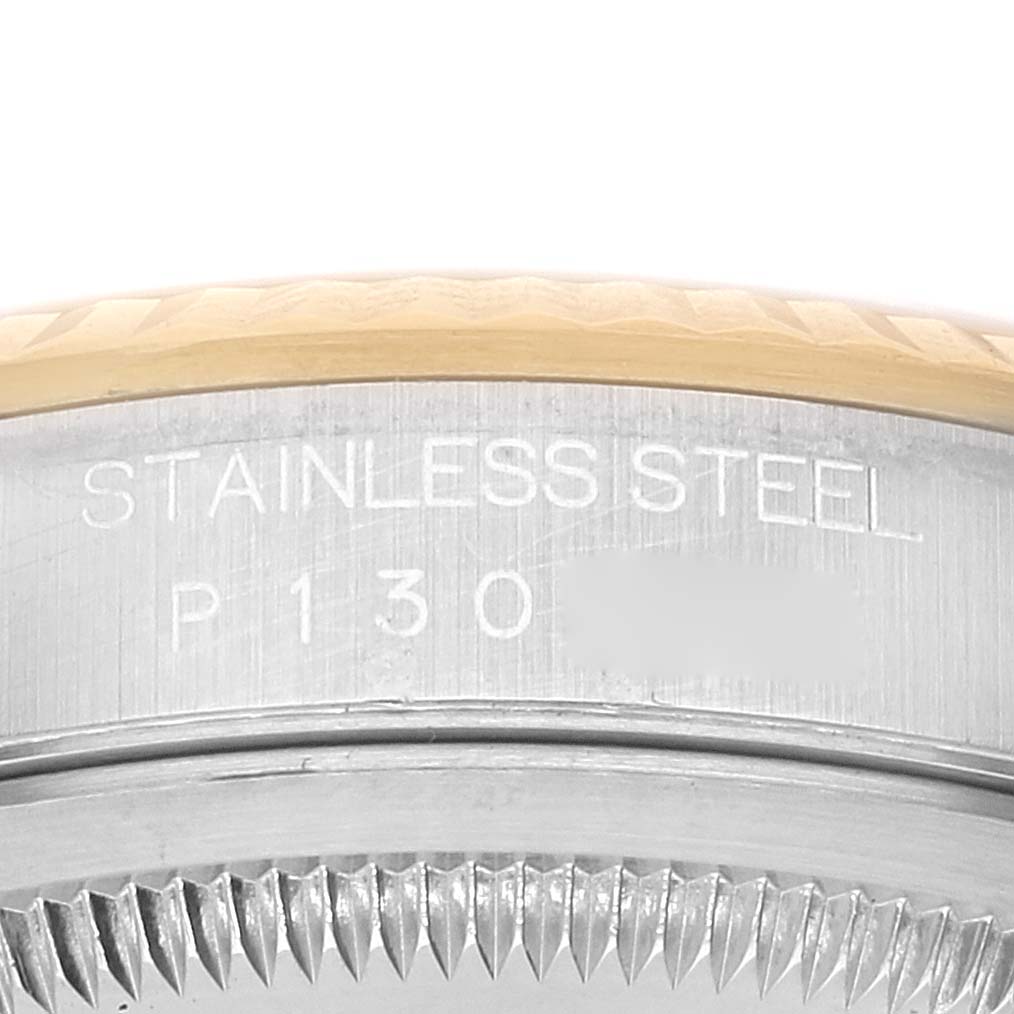 The image shows a close-up, side view of the stainless steel casing of a Rolex Datejust 16233 Men's Steel and Gold (two tone) Champagne Dial 16233 Men's Steel and Gold (two tone) Champagne Dial watch, highlighting the engraved text.