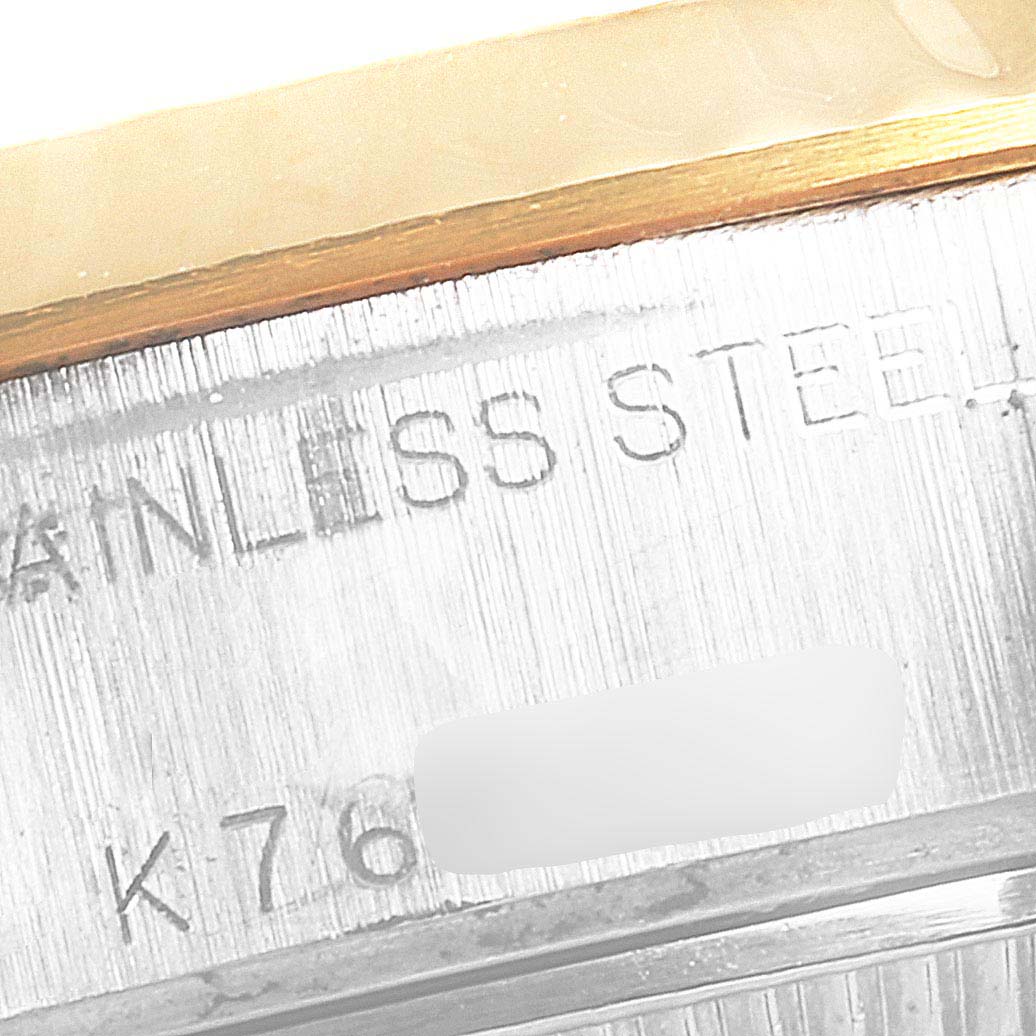 This image shows a close-up of the engraved markings on the side of a Rolex Datejust 79173 Women's Steel and Gold (two tone) Silver Dial 79173 Women's Steel and Gold (two tone) Silver Dial watch case.