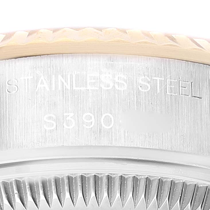 This image shows the side engraving details of a stainless steel Rolex Datejust 69173 Women
s Steel and Gold (two tone) White Dial 69173 Women
s Steel and Gold (two tone) White Dial watch, focusing on the serial number and bezel.