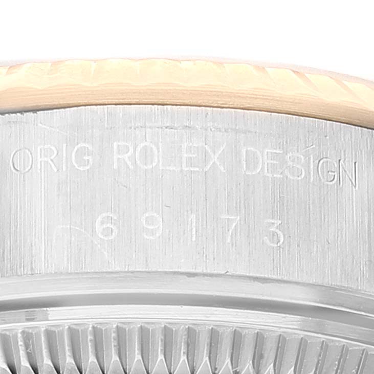 The image shows a close-up of the case side and bezel of a Rolex Datejust 69173 Women
s Steel and Gold (two tone) White Dial 69173 Women
s Steel and Gold (two tone) White Dial, featuring the engraved model number "69173" and "ORIG ROLEX DESIGN."