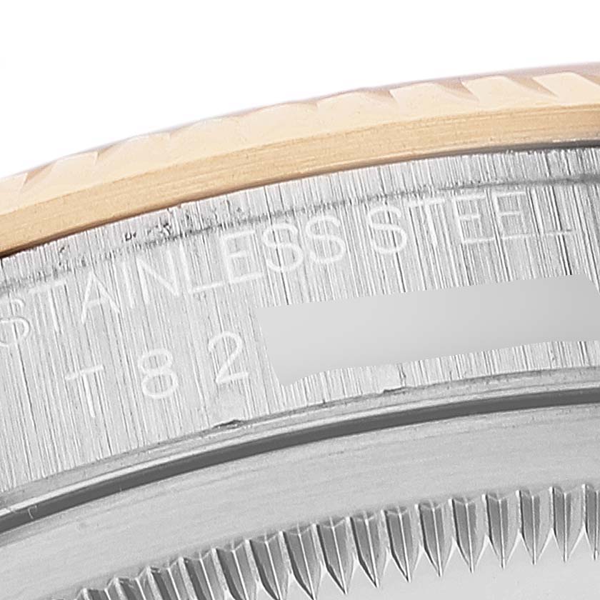 The image shows a close-up angle of the stainless steel edge and part of the fluted bezel of a Rolex Datejust 16233 Men
s Steel and Gold (two tone) Grey Dial 16233 Men
s Steel and Gold (two tone) Grey Dial watch.