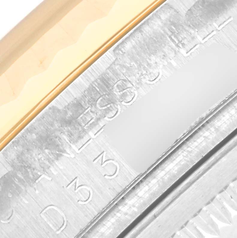 Close-up angle showing part of the bezel and the side engraving of the Rolex Datejust 116233 Men's Steel and Gold (two tone) White Dial 116233 Men's Steel and Gold (two tone) White Dial watch.
