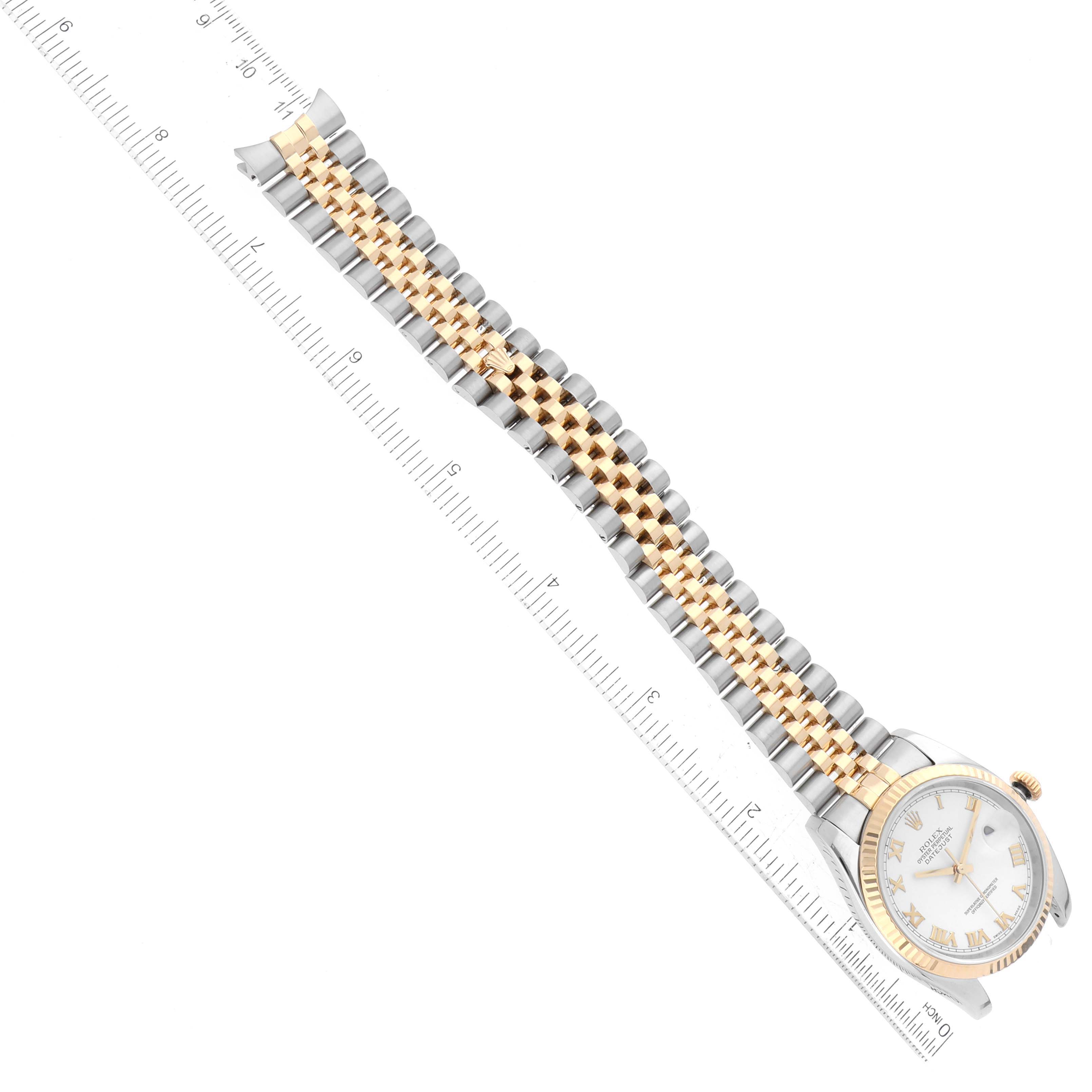 The image shows an angled view of a Rolex Datejust 116233 Men's Steel and Gold (two tone) White Dial 116233 Men's Steel and Gold (two tone) White Dial watch, highlighting the face, bezel, and two-tone bracelet alongside a ruler.