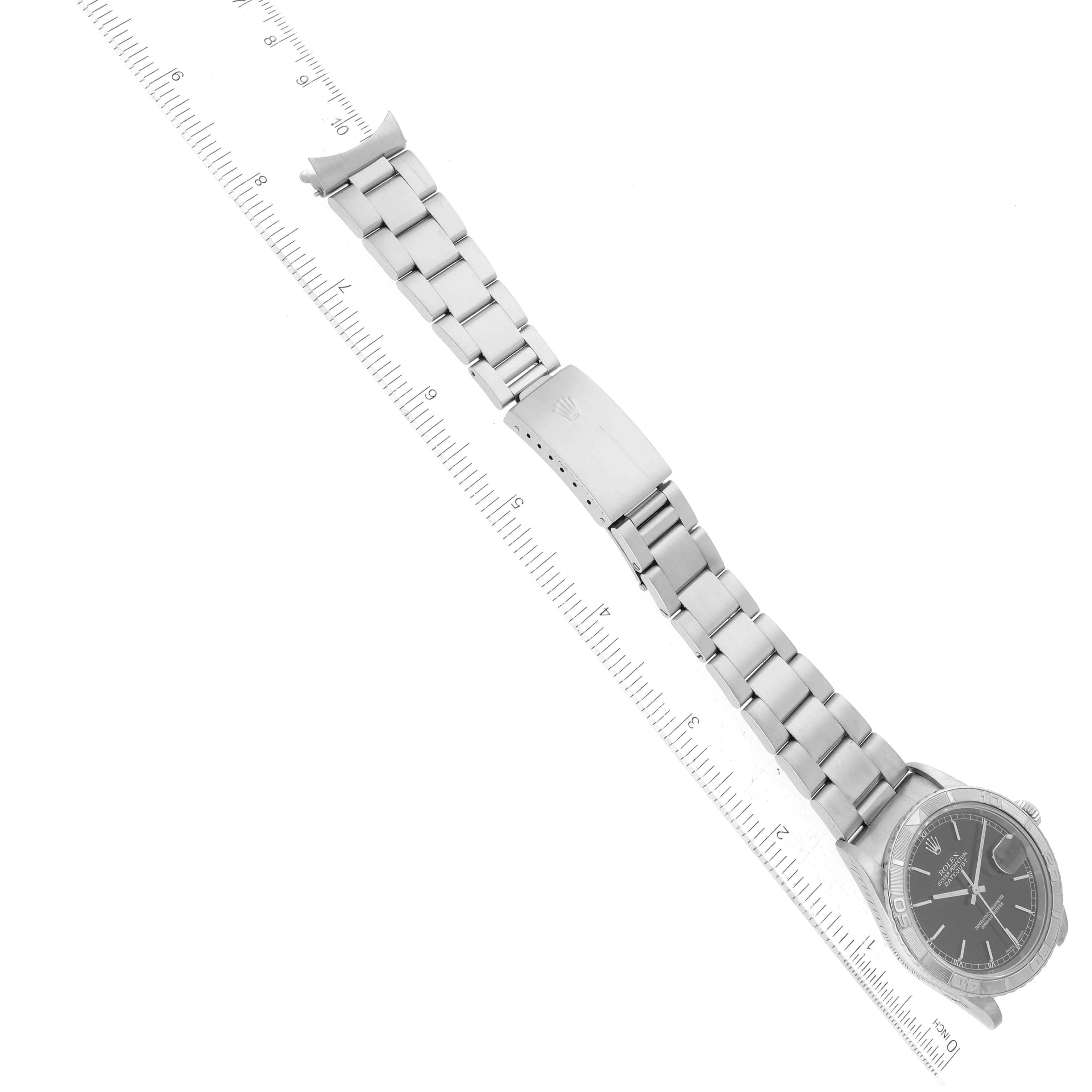 The image shows a Rolex Turn-o-Graph 16264 Men's Stainless Steel Black Dial 16264 Men's Stainless Steel Black Dial watch laid flat, displaying its face, bezel, and metal bracelet alongside a ruler.