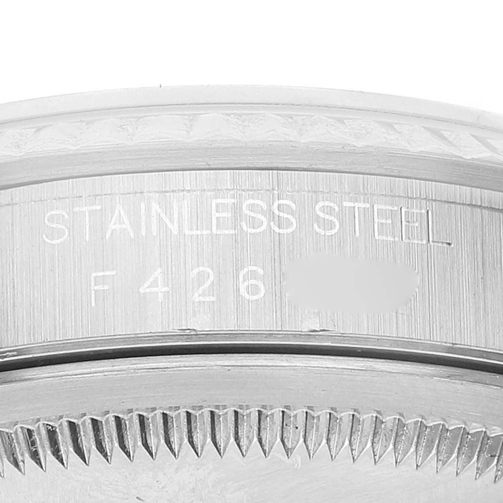 The image shows a close-up of the side of a Rolex Datejust 16234 Men's Stainless Steel White Dial 16234 Men's Stainless Steel White Dial watch, highlighting the serial number and stainless steel engraving.