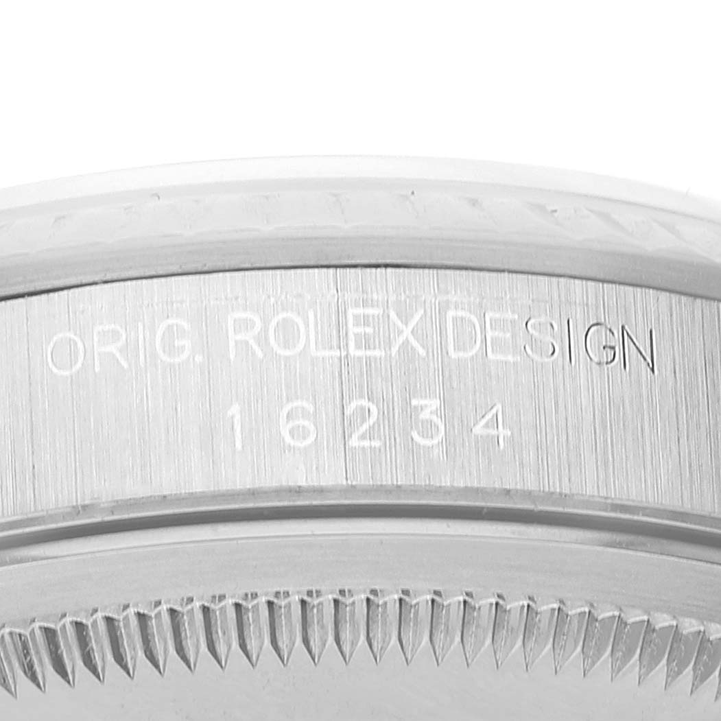 This image shows a close-up of the side of a Rolex Datejust 16234 Men's Stainless Steel White Dial 16234 Men's Stainless Steel White Dial watch case, featuring engraved text.