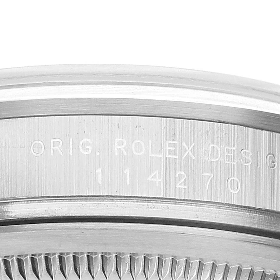 This close-up image shows the side engraving and part of the bezel of a Rolex Explorer 114270 Men's Stainless Steel Black Dial 114270 Men's Stainless Steel Black Dial watch.