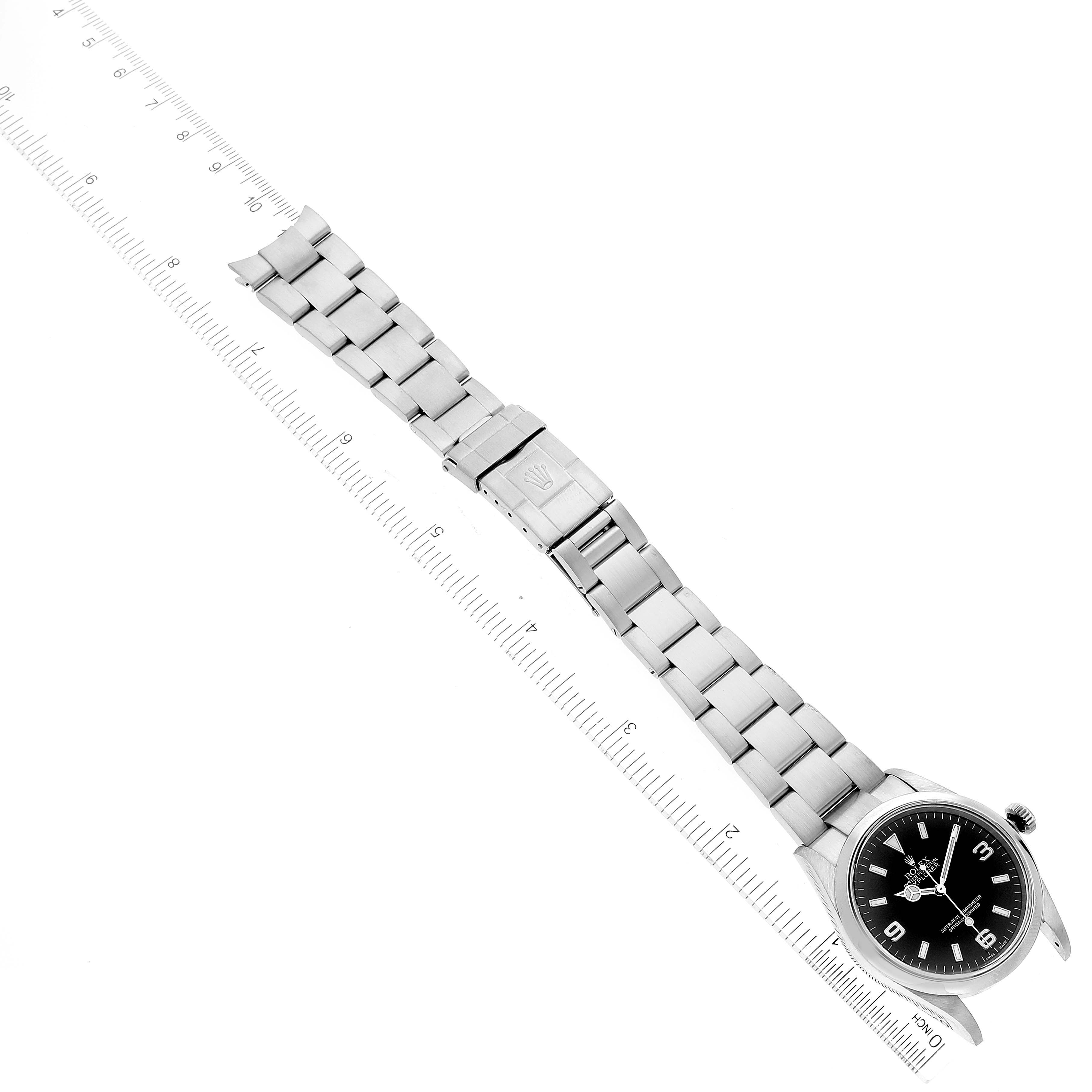 The image shows a stainless steel Rolex Explorer 114270 Men's Stainless Steel Black Dial 114270 Men's Stainless Steel Black Dial model watch laid flat with measurements beside it, displaying the bracelet and face from an overhead angle.