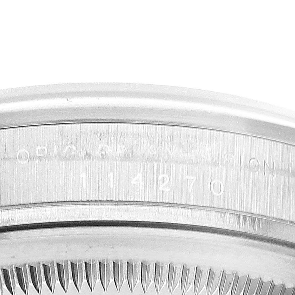 The image shows a close-up view of the case and serial number of a Rolex Explorer 114270 Men's Stainless Steel Black Dial 114270 Men's Stainless Steel Black Dial watch.