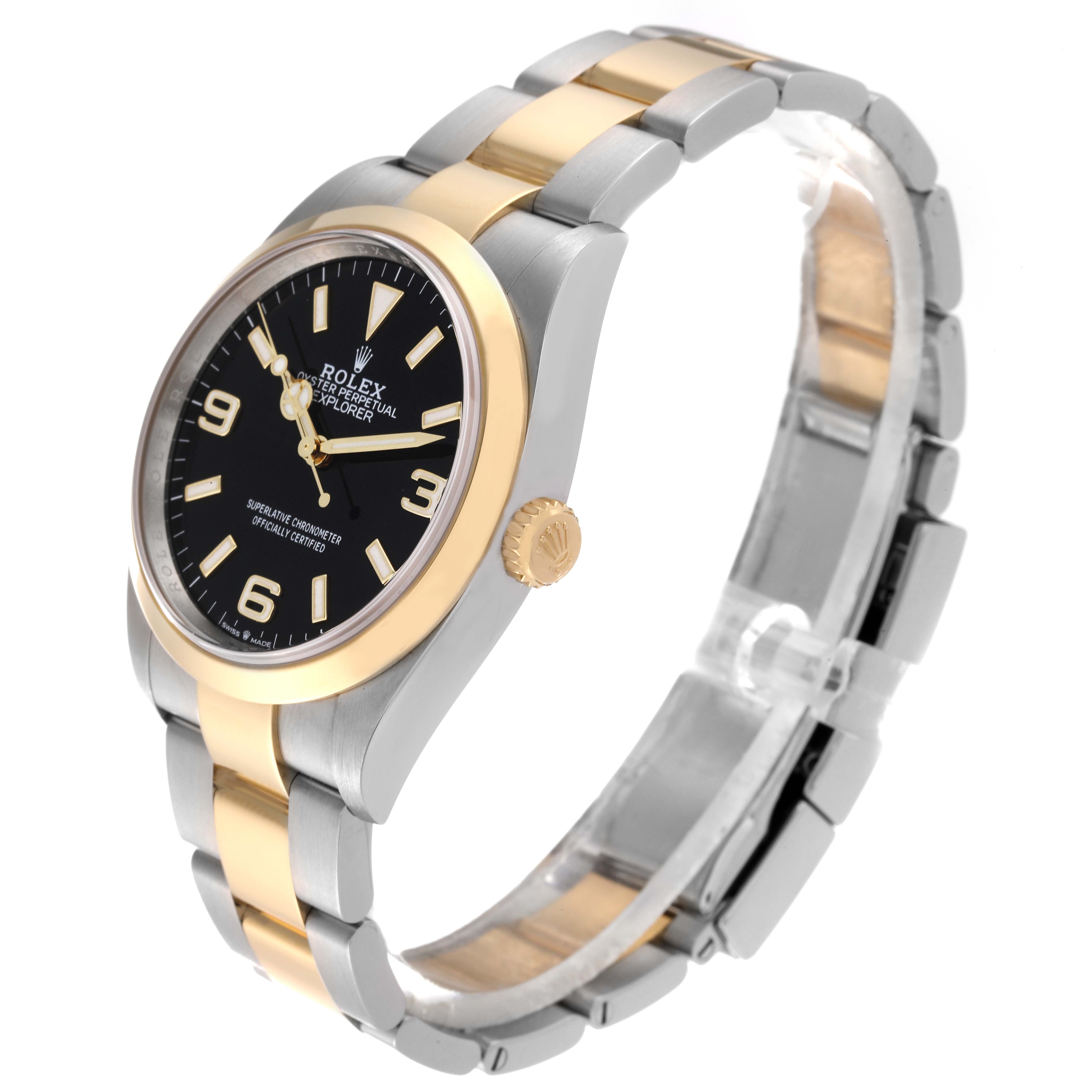 The Rolex Explorer 124273 Men
s Steel and Gold (two tone) Black Dial 124273 Men
s Steel and Gold (two tone) Black Dial watch is shown at an angle, displaying the dial, bezel, crown, and bracelet.