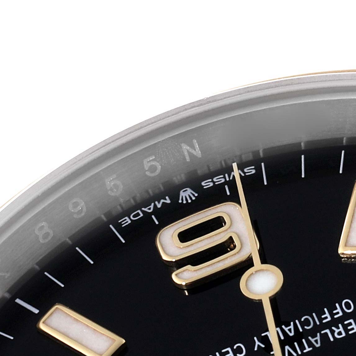 This image shows a close-up of the Explorer model by Rolex, focusing on the top part of the dial, numeral 9, and part of the bezel.