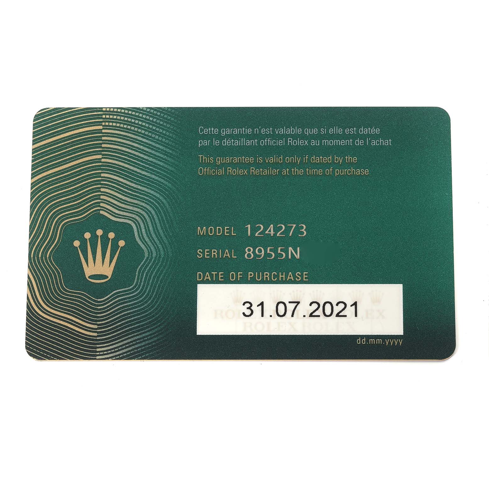 The image shows a green warranty card for a Rolex Explorer 124273 Men
s Steel and Gold (two tone) Black Dial 124273 Men
s Steel and Gold (two tone) Black Dial model 124273 watch, highlighting the serial number and purchase date.