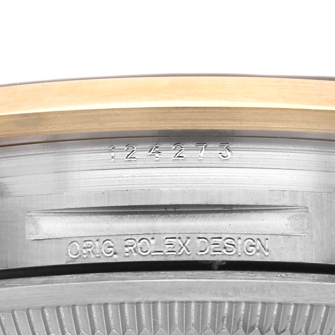 This image shows a close-up of the case back with engraved text on a Rolex Explorer 124273 Men
s Steel and Gold (two tone) Black Dial 124273 Men
s Steel and Gold (two tone) Black Dial watch.