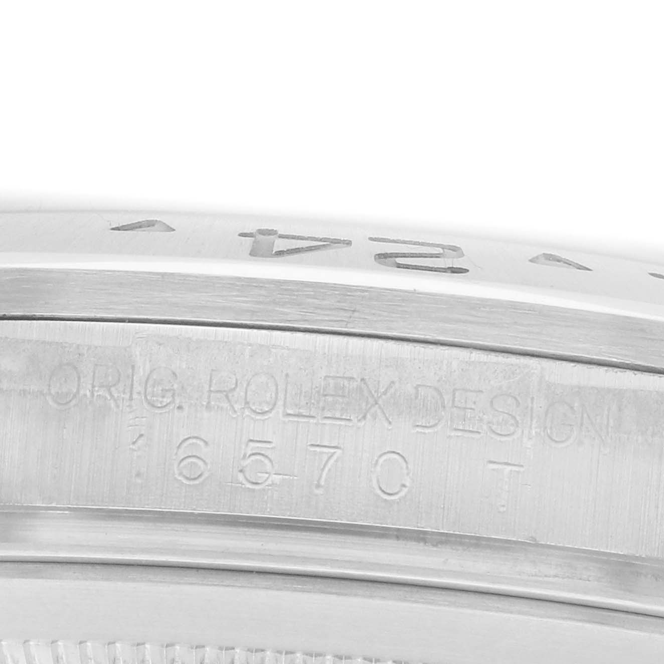 The image shows a close-up of the case side of a Rolex Explorer 16570 Men
s Stainless Steel Black Dial, highlighting engravings and the bezel edge.