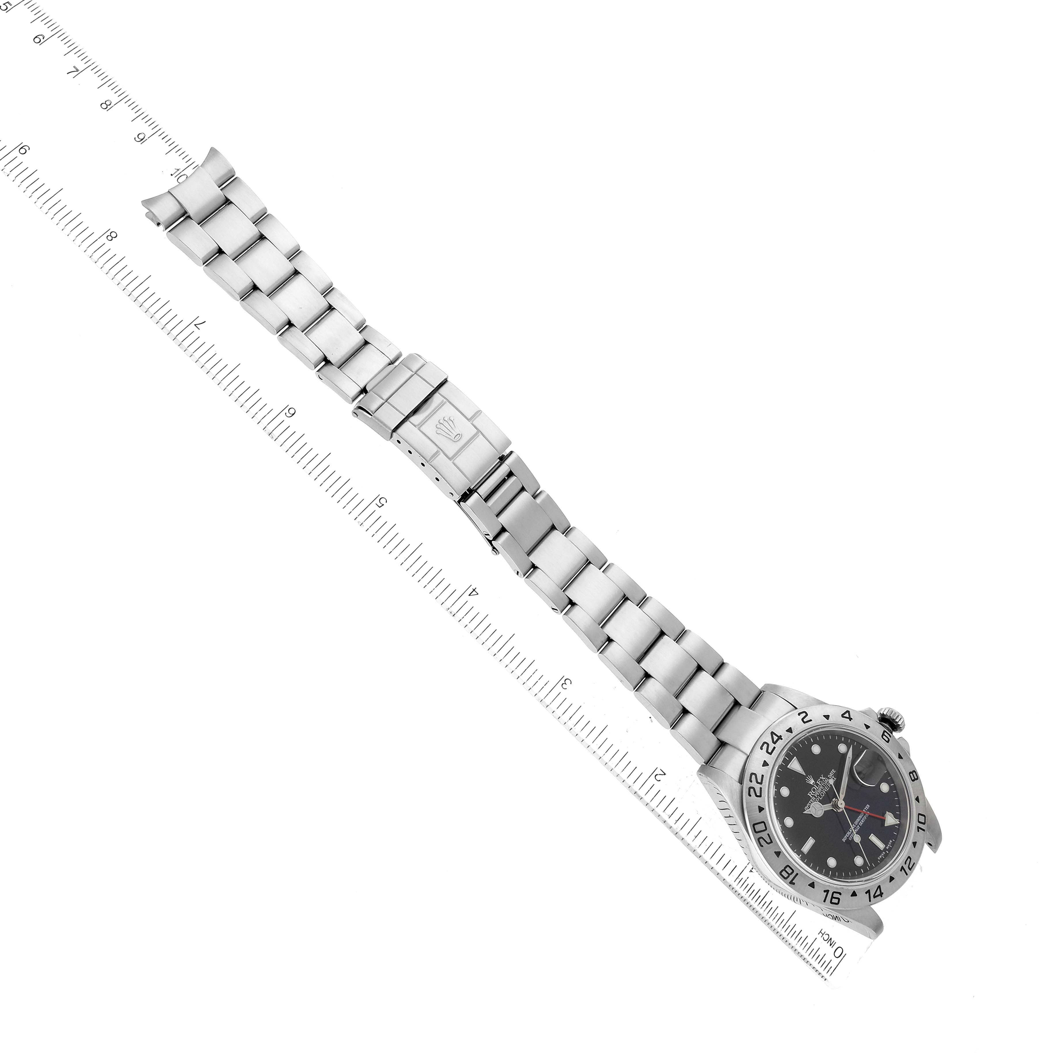 The image shows a Rolex Explorer 16570 Men's Stainless Steel Black Dial 16570 Men's Stainless Steel Black Dial watch laying flat with its bracelet fully extended, alongside a ruler for scale.