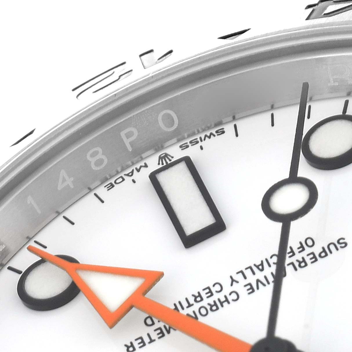 This close-up image shows the dial and part of the bezel of a Rolex Explorer 226570 Men
s Stainless Steel White Dial 226570 Men
s Stainless Steel White Dial watch, highlighting the hour markers and an orange hand.