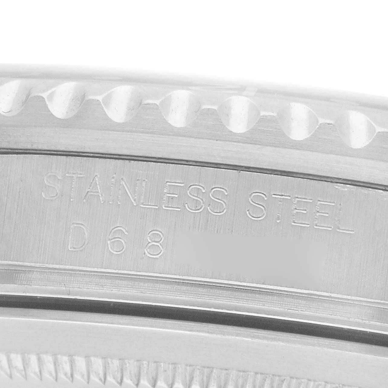 The image shows a close-up of the side of a Rolex GMT-Master 16710 Men
s Stainless Steel Black Dial watch case, highlighting the stainless steel engraving.