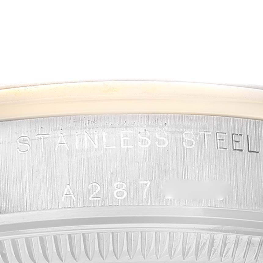 The image shows a partial view of the stainless steel back case with engravings of a Mid-Size Rolex watch.