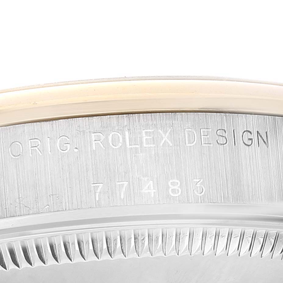 This close-up image shows the engraving on the case back of a Mid-Size Rolex watch with "ORIG. ROLEX DESIGN" and a reference number.