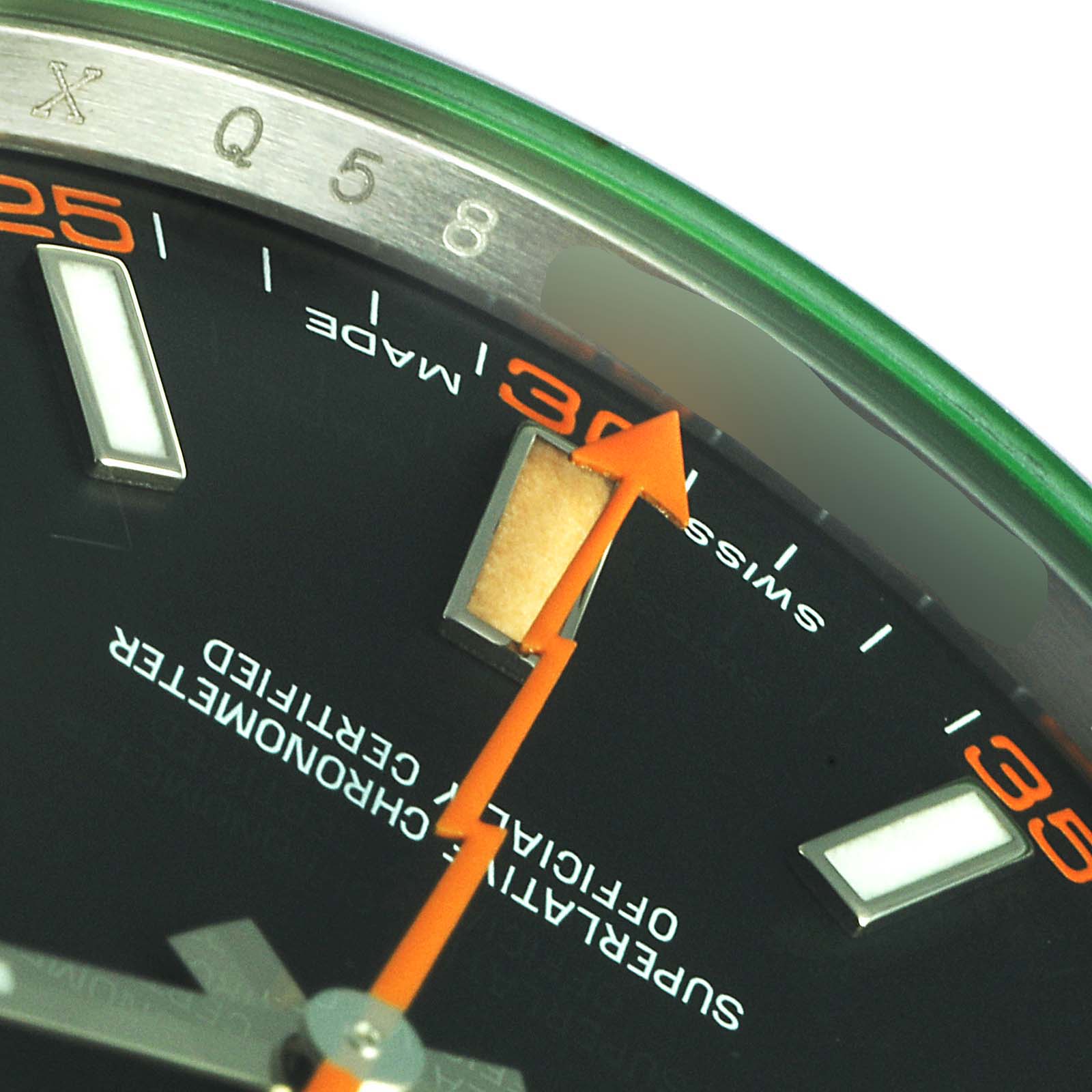 This close-up image of a Rolex Milgauss 116400GV Men's Stainless Steel Black Dial 116400GV Men's Stainless Steel Black Dial watch shows part of the dial, the orange lightning bolt second hand, and the hour markers.