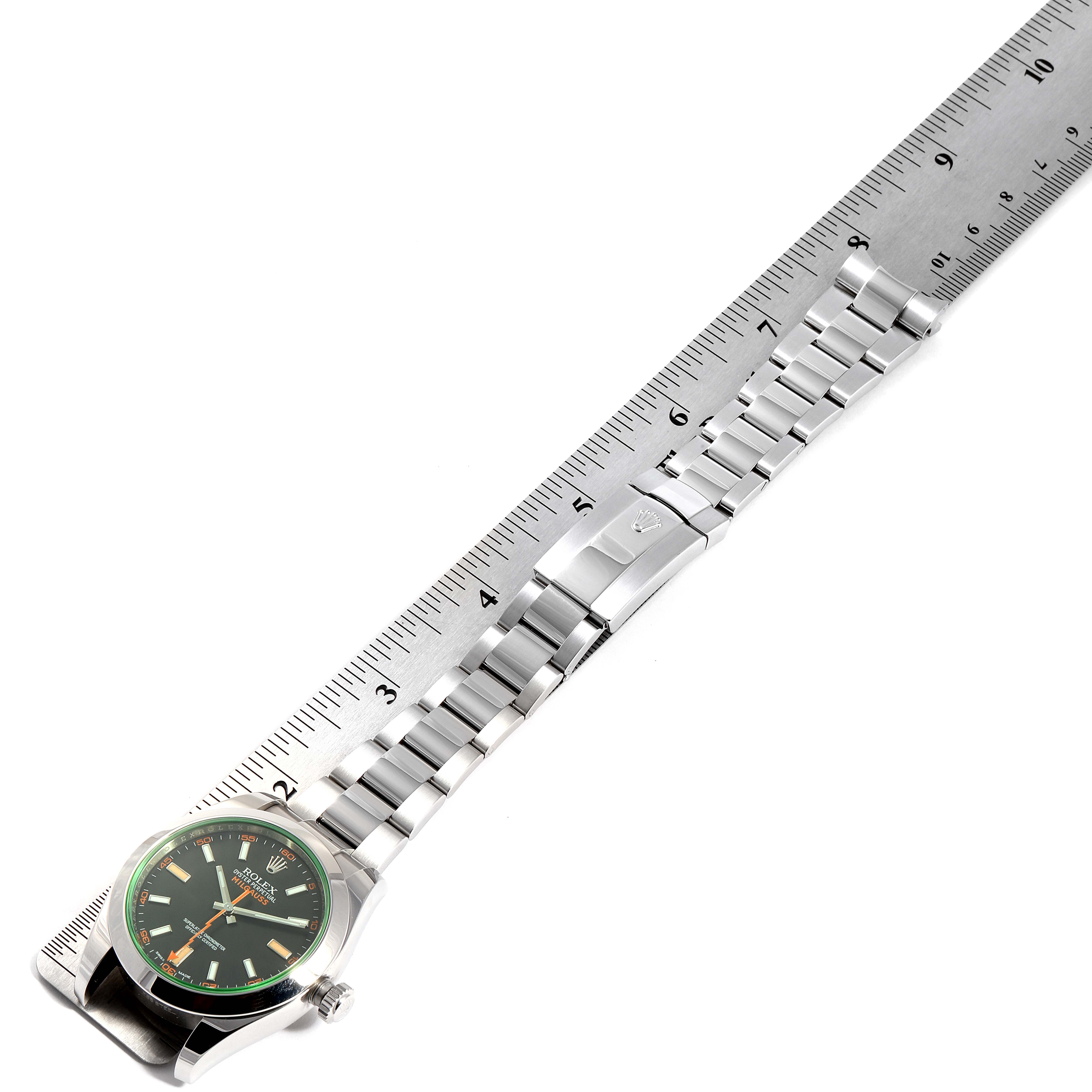 This image shows a Rolex Milgauss 116400GV Men's Stainless Steel Black Dial 116400GV Men's Stainless Steel Black Dial watch laid flat next to a ruler, displaying the face, bracelet, and clasp.
