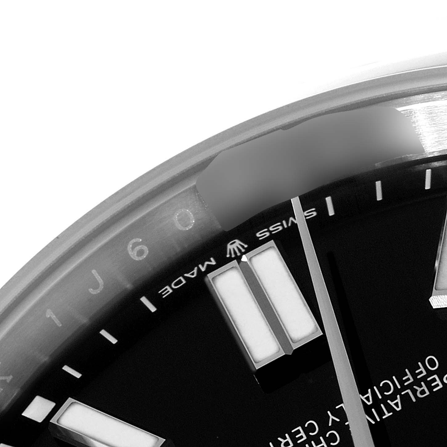 This image shows a close-up of the dial and bezel of the Rolex Oyster Perpetual 124300 Men's Stainless Steel Black Dial 124300 Men's Stainless Steel Black Dial watch highlighting the "Swiss Made" text.
