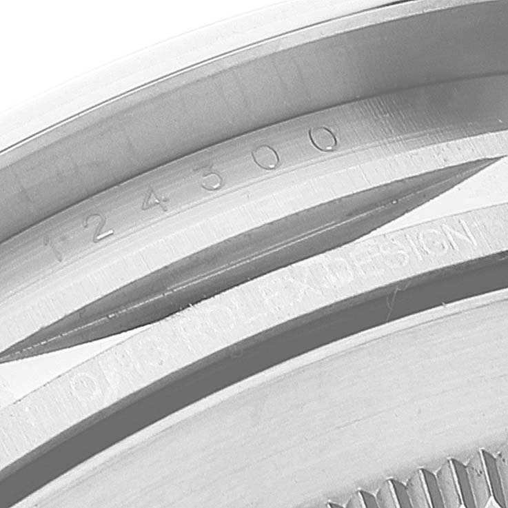 The image shows a close-up of the side edge of a Rolex Oyster Perpetual 124300 Men's Stainless Steel Black Dial 124300 Men's Stainless Steel Black Dial watch, displaying part numbers and "Rolex Design."