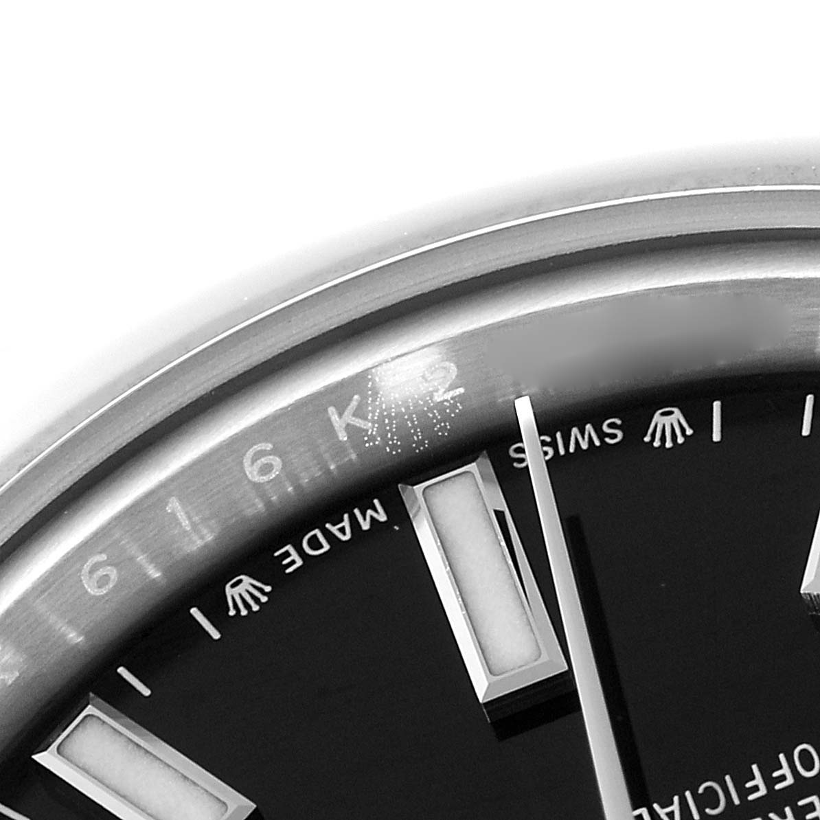 The image shows a close-up of the Rolex Oyster Perpetual 276200 Women's Stainless Steel Black Dial 276200 Women's Stainless Steel Black Dial watch's face, including parts of the bezel, dial, markers, and hands.