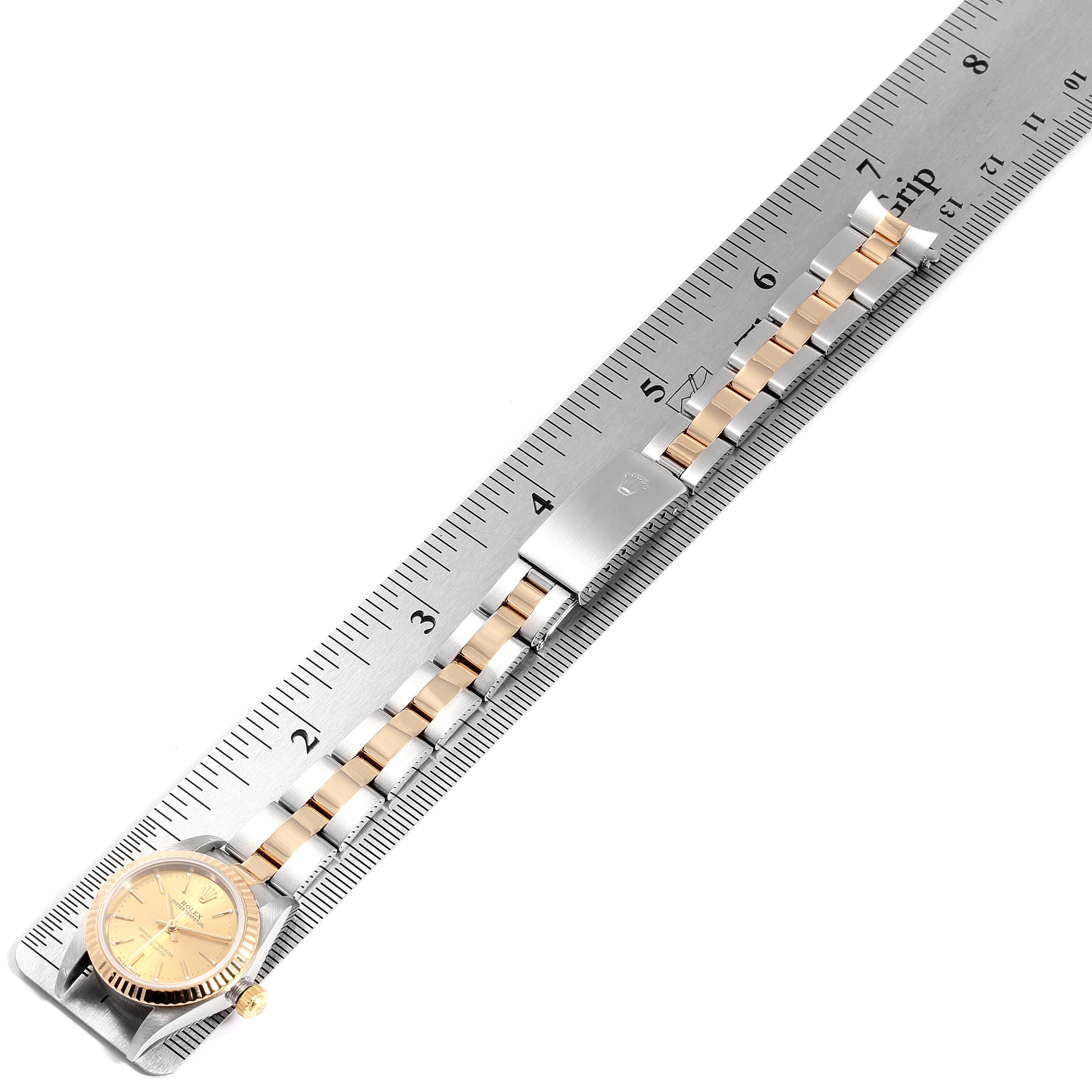 The Rolex Datejust 76193 Women's Steel and Gold (two tone) Champagne Dial 76193 Women's Steel and Gold (two tone) Champagne Dial watch is shown at an overhead angle with a measuring ruler, including the face and bracelet.