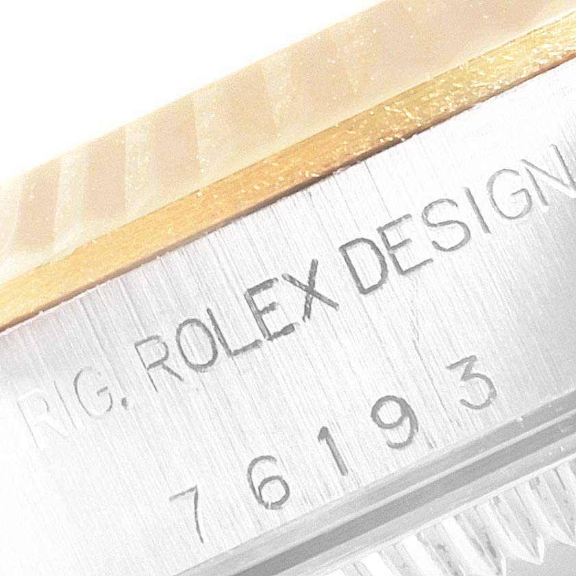 This image shows a close-up of the Rolex Datejust 76193 Women's Steel and Gold (two tone) Champagne Dial 76193 Women's Steel and Gold (two tone) Champagne Dial model, specifically focusing on the bezel and engraved design markings.
