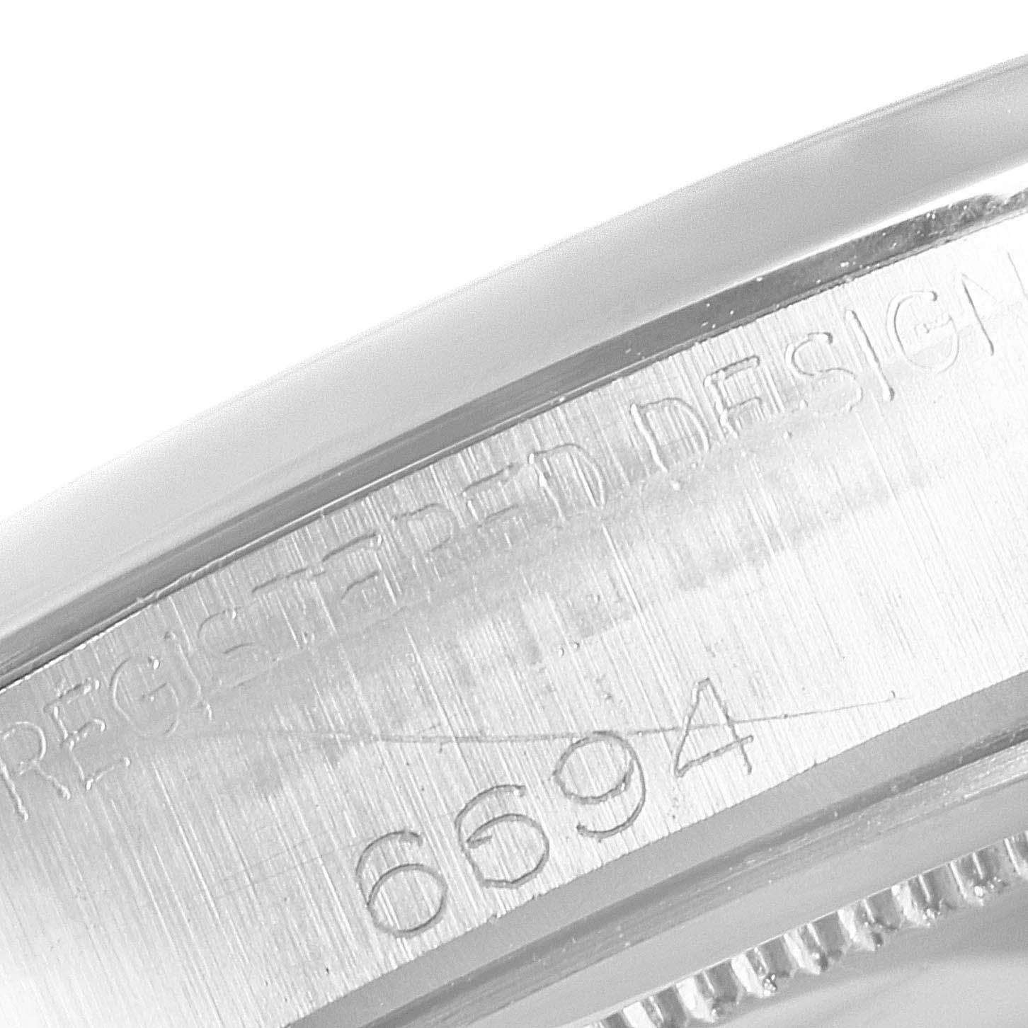 The image shows a close-up of the side of the caseback of a Rolex Vintage Collection 6694 Men's Stainless Steel Black Dial 6694 Men's Stainless Steel Black Dial model, highlighting the engraved model number "6694."