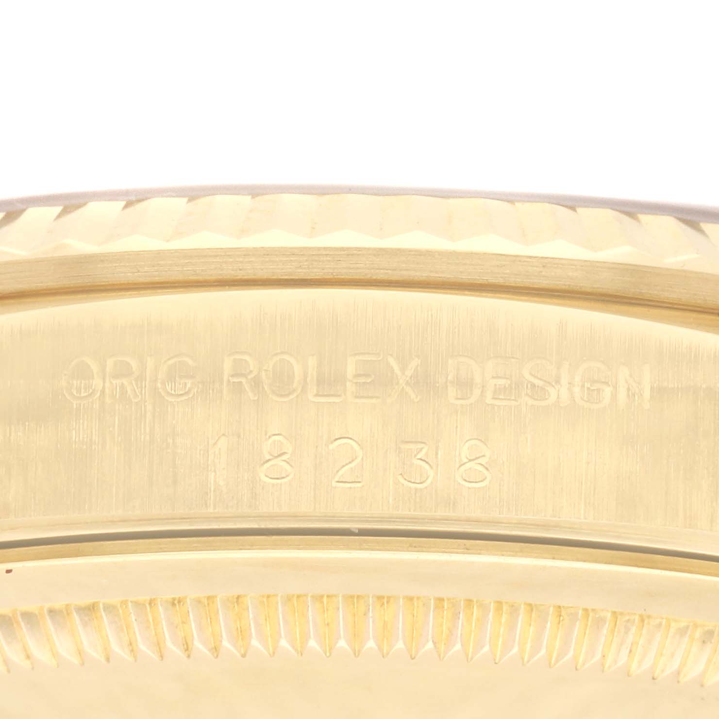 This close-up image shows the side view of a Rolex President 18238 Men's Yellow Gold Grey Dial 18238 Men's Yellow Gold Grey Dial model, highlighting the inscription and bezel detail.