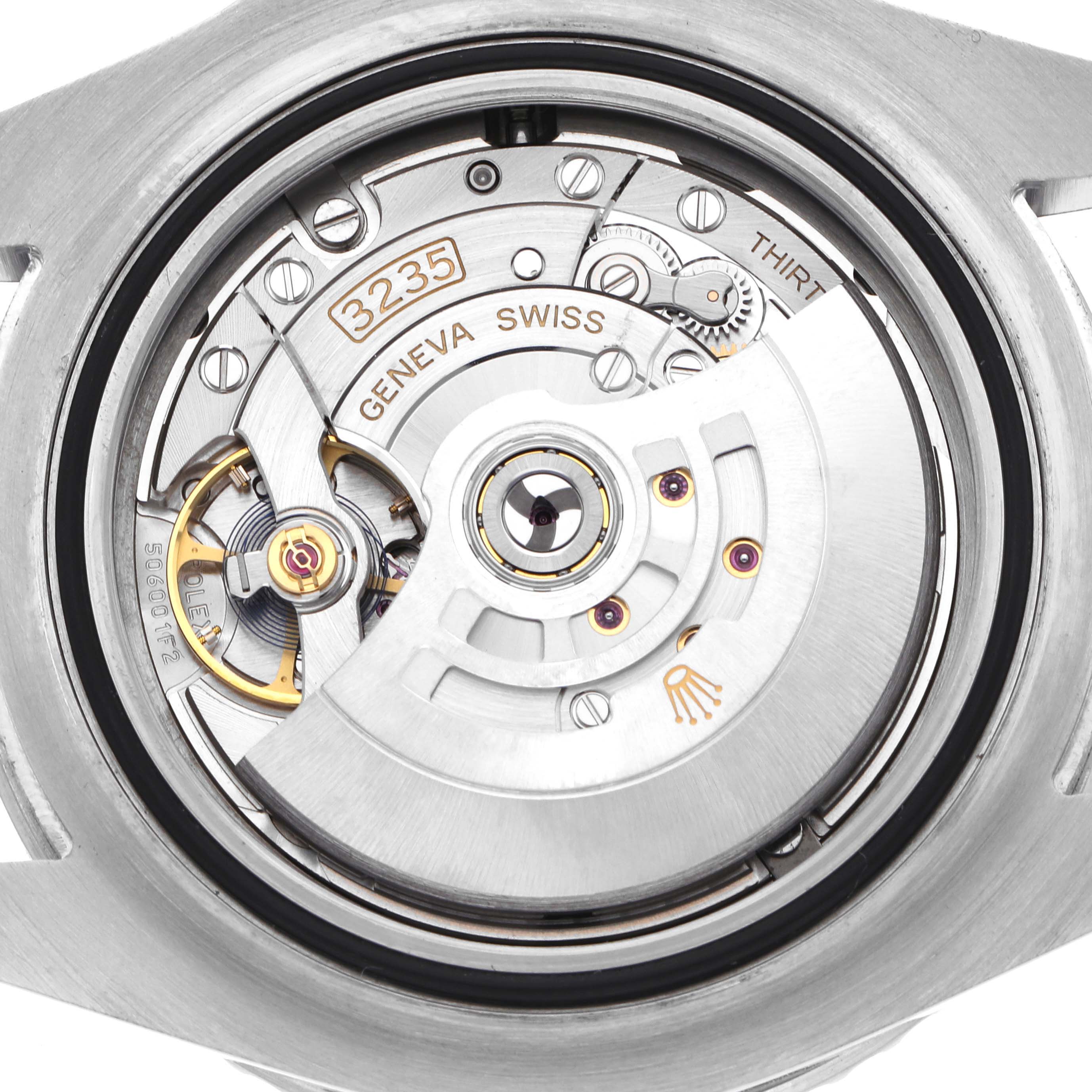 The image shows the movement of a Rolex Sea-Dweller 126600 Men
s Stainless Steel Black Dial, showcasing the intricate internal mechanics from a rear angle.