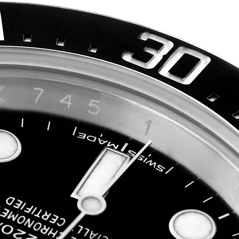 The image shows a close-up of the bezel and dial of a Rolex Sea-Dweller 126600 Men
s Stainless Steel Black Dial, focusing on the "30" mark and part of the dial.