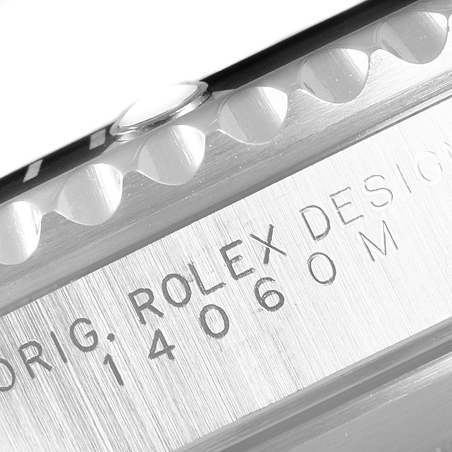 This image shows a close-up angle of the case and bezel of a Rolex Submariner 14060 Men
s Stainless Steel Black Dial 14060 Men
s Stainless Steel Black Dial watch, displaying the model number and "ROLEX DESIGN" engraving.
