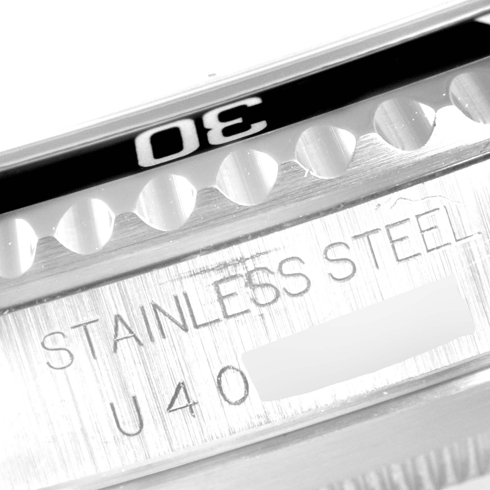 This image shows a close-up of the bezel and engraved caseback of a Rolex Submariner 14060 Men
s Stainless Steel Black Dial 14060 Men
s Stainless Steel Black Dial watch, focusing on the "30" mark and "STAINLESS STEEL" engraving.