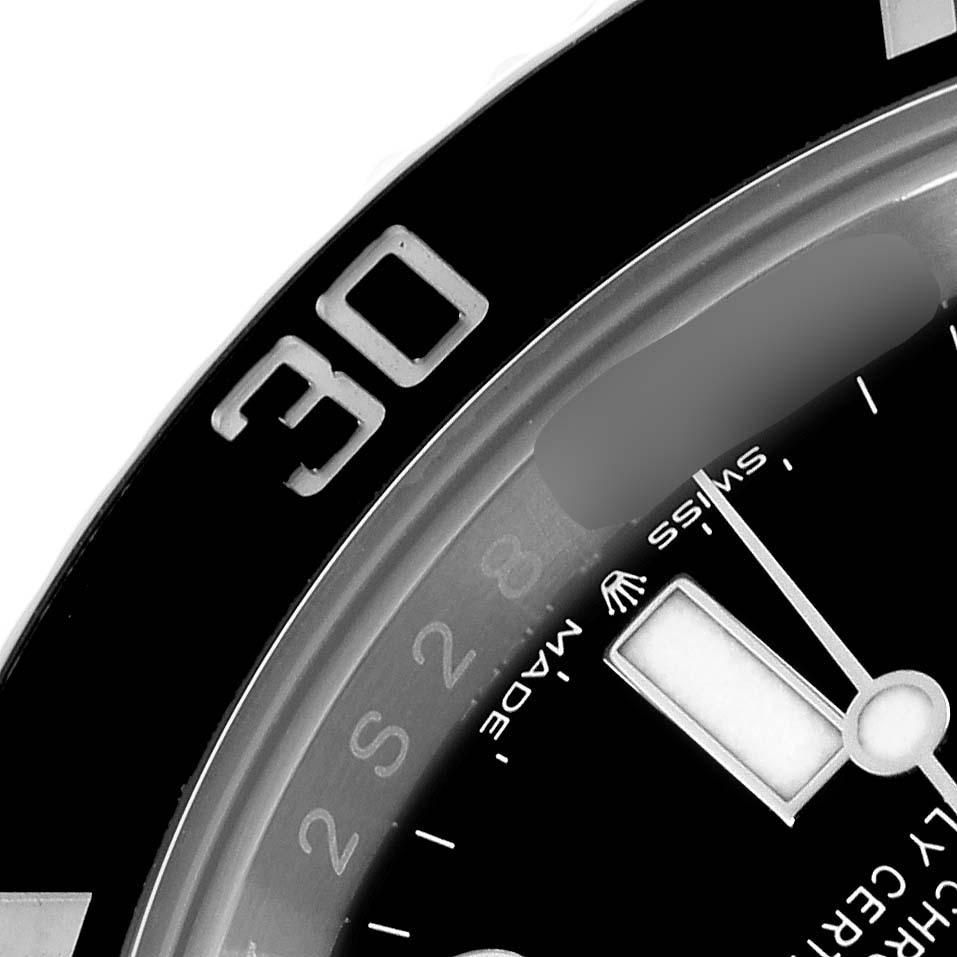 The angle shows a close-up of the bezel and partial dial of a Rolex Submariner 126610 Men
s Stainless Steel Black Dial watch, featuring the "30" mark and part of the hands.