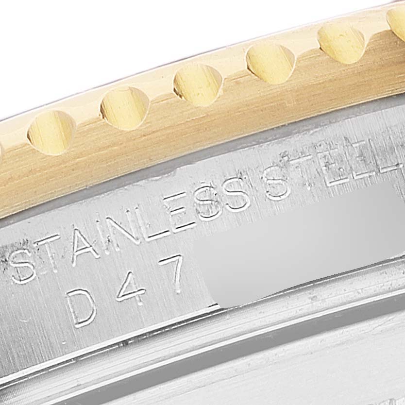 This close-up image shows the engraved back and the edge of the bezel of a Rolex Submariner 16613 Men
s Steel and Gold (two tone) Blue Dial 16613 Men
s Steel and Gold (two tone) Blue Dial watch.