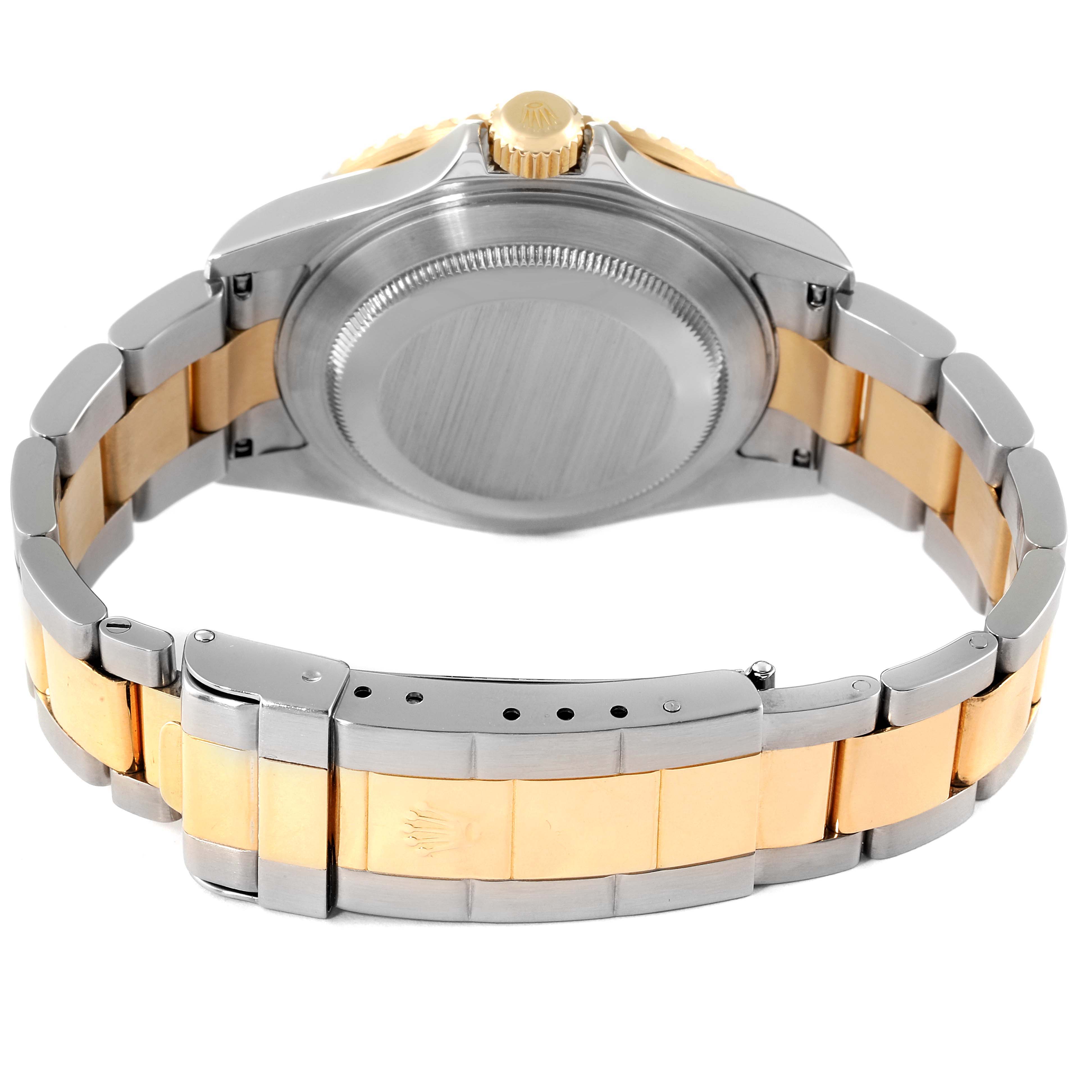 The image shows the back view of a Rolex Submariner 16613 Men
s Steel and Gold (two tone) Blue Dial 16613 Men
s Steel and Gold (two tone) Blue Dial
s case and two-tone bracelet.