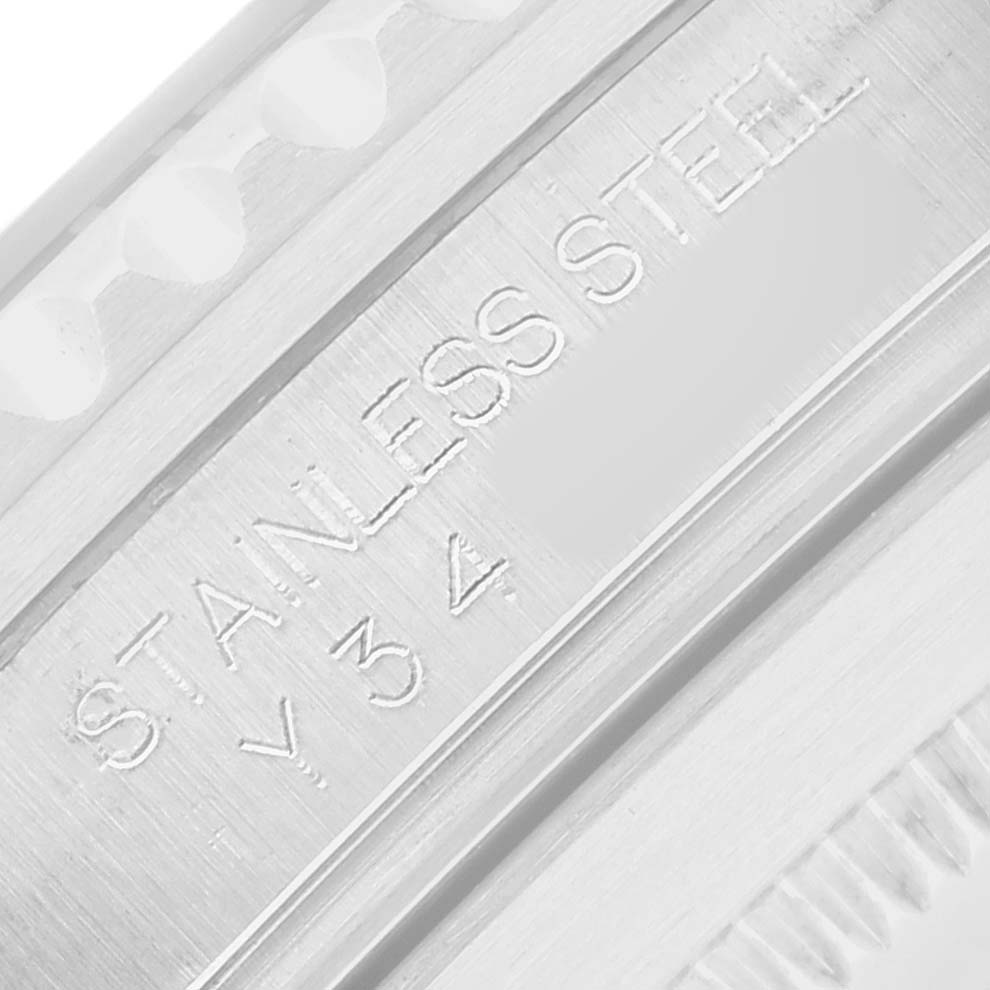 The image shows a close-up of the engraved "STAINLESS STEEL" on the case of a Rolex Submariner 16610 Men
s Stainless Steel Black Dial watch.