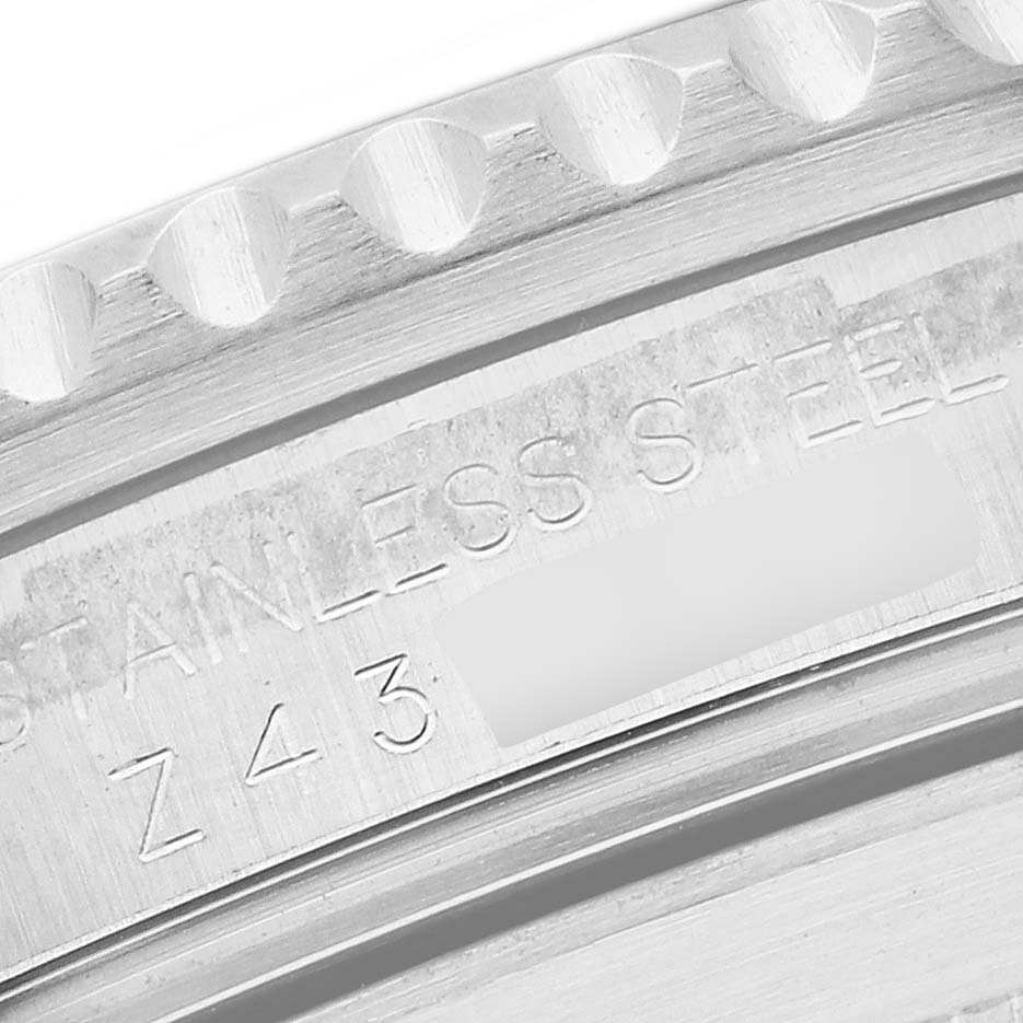 This close-up image shows the stainless steel case and engraved serial number of a Rolex Submariner 16610 Men's Stainless Steel Black Dial 16610 Men's Stainless Steel Black Dial watch.