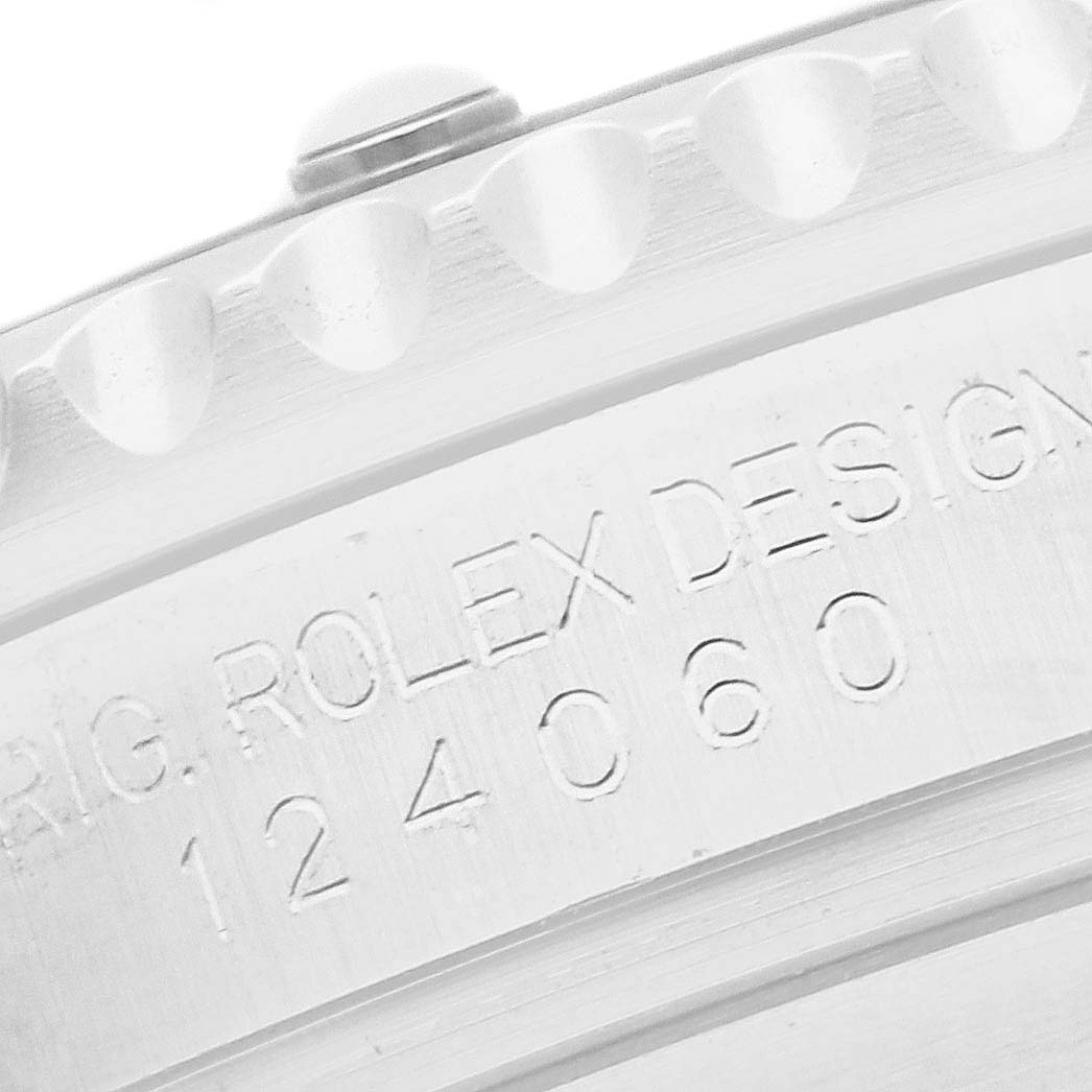 The image shows a close-up of the side of a Rolex Submariner 124060 Men
s Stainless Steel Black Dial, highlighting the engraved model number and part of the bezel.