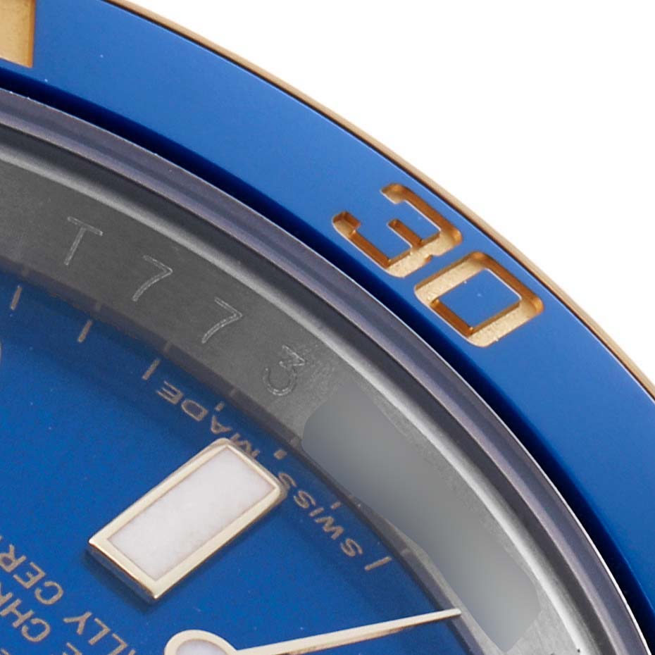 The image shows a close-up of the blue bezel and part of the dial of a Rolex Submariner 116613 Men
s Steel and Gold (two tone) Blue Dial watch, highlighting the numeral "30".