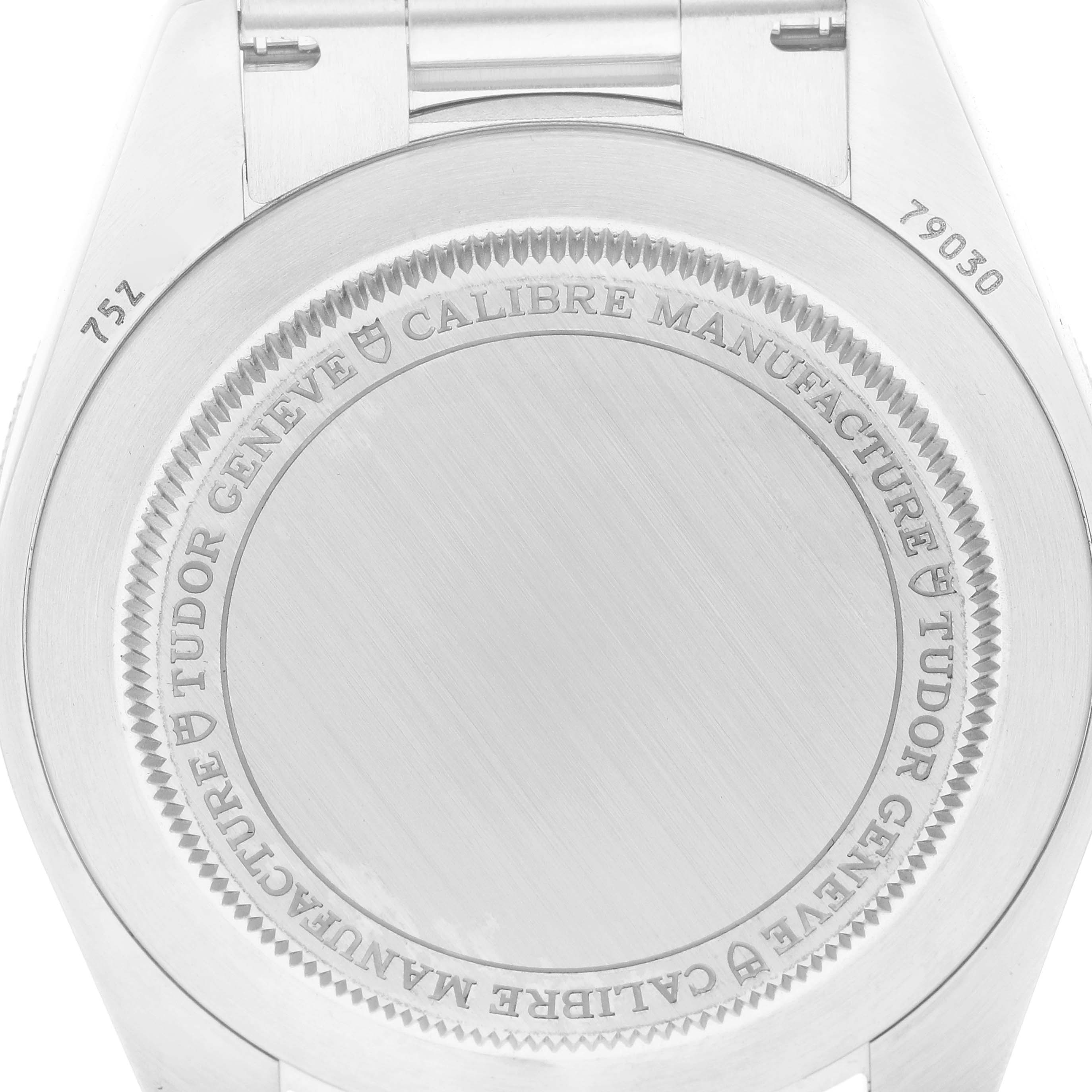 The image shows the back case of a Tudor Heritage Black Bay 79030B Men
s Stainless Steel Blue Dial watch, displaying engravings around the edge.