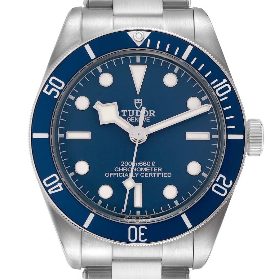 The Tudor Heritage Black Bay model 79030B is shown from the front, displaying the blue dial, bezel, hands, hour markers, and part of the bracelet.