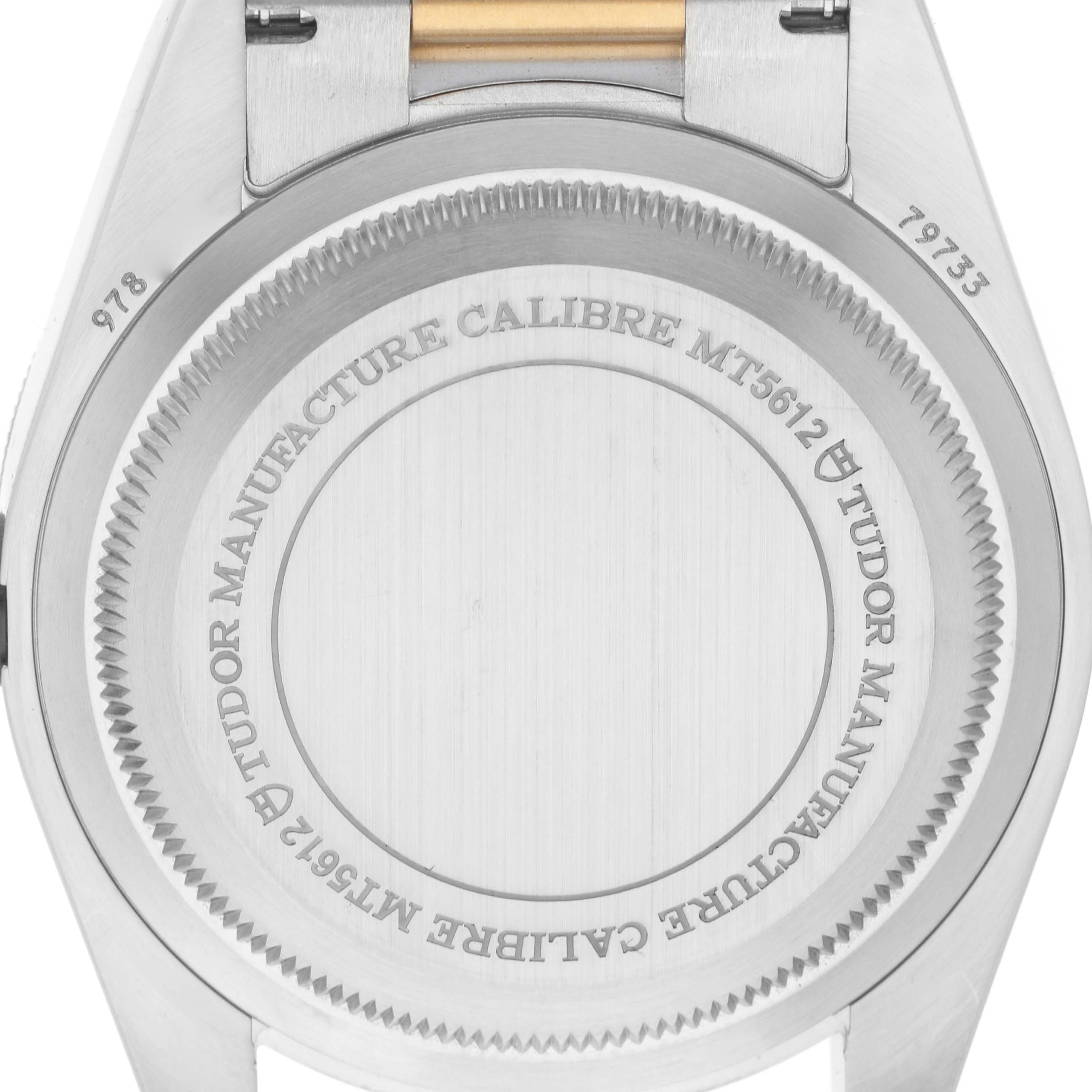 The image shows the back case of a Tudor Heritage Black Bay 79733 Men
s Steel and Gold (two tone) Black Dial watch, highlighting the engraving details.