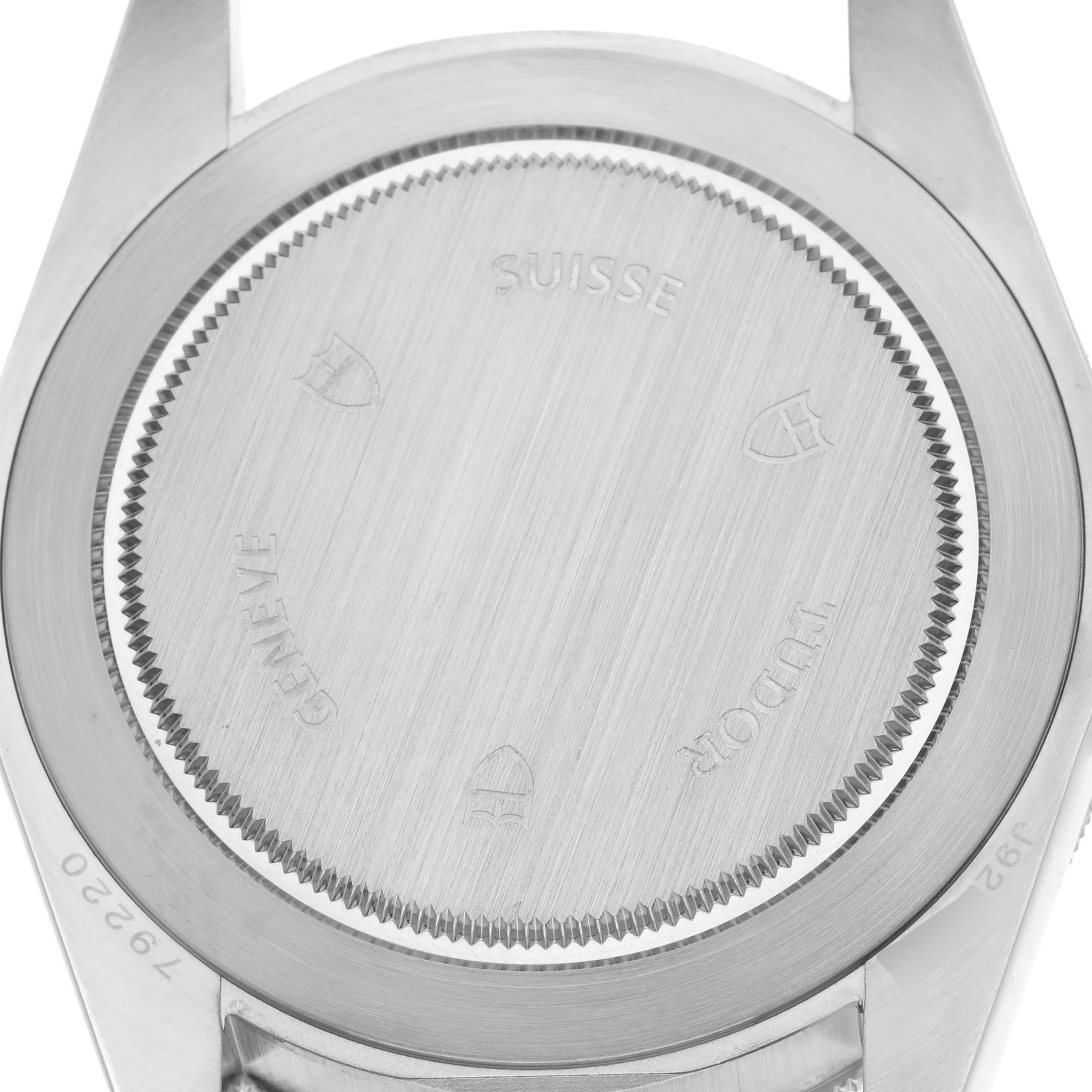 The image shows the back case of a Tudor Heritage Black Bay 79220R Men
s Stainless Steel Black Dial 79220R Men
s Stainless Steel Black Dial watch viewed from a top-down angle.