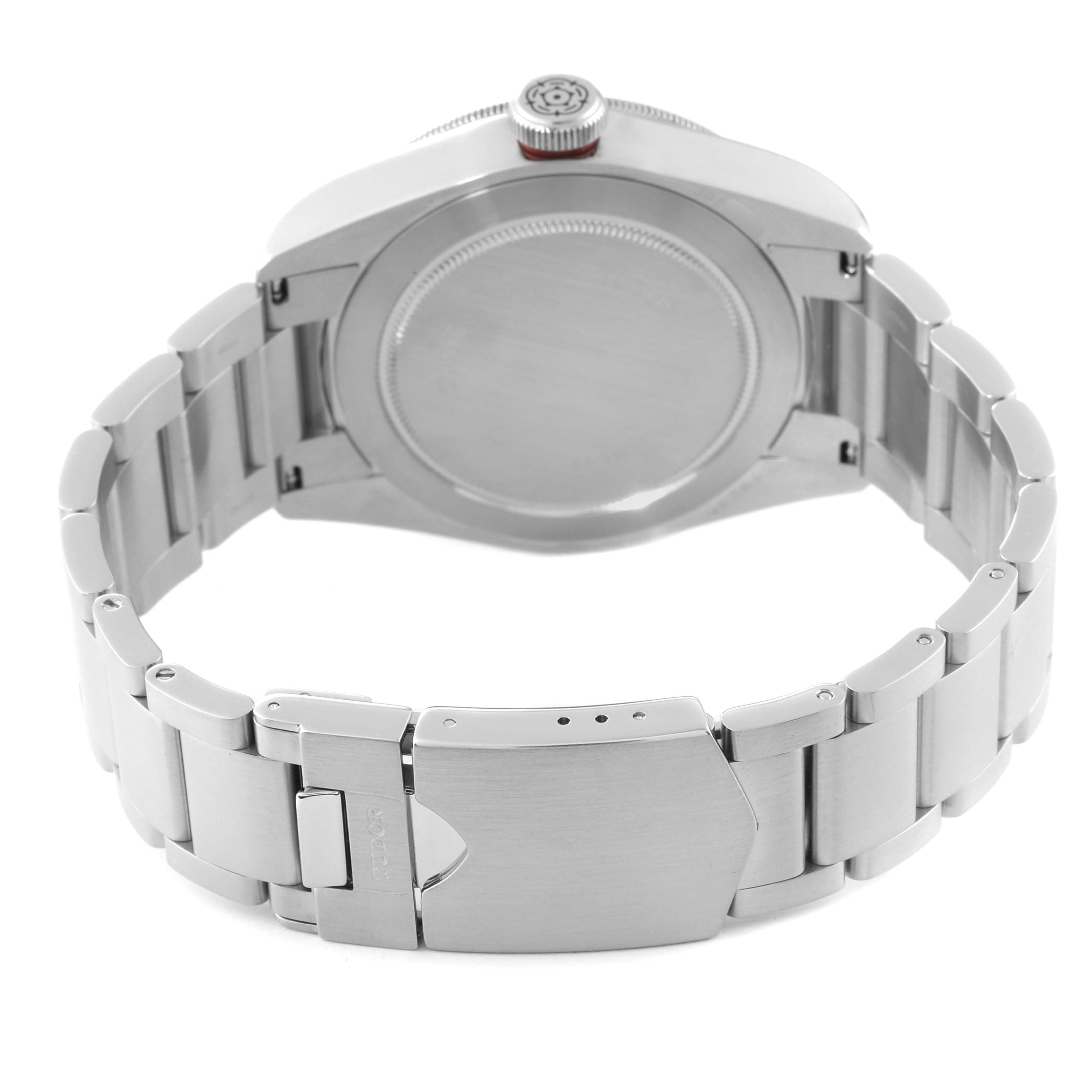 This is a Heritage Black Bay watch by Tudor, shown from the back, highlighting the case back, crown, and the metal bracelet with clasp.