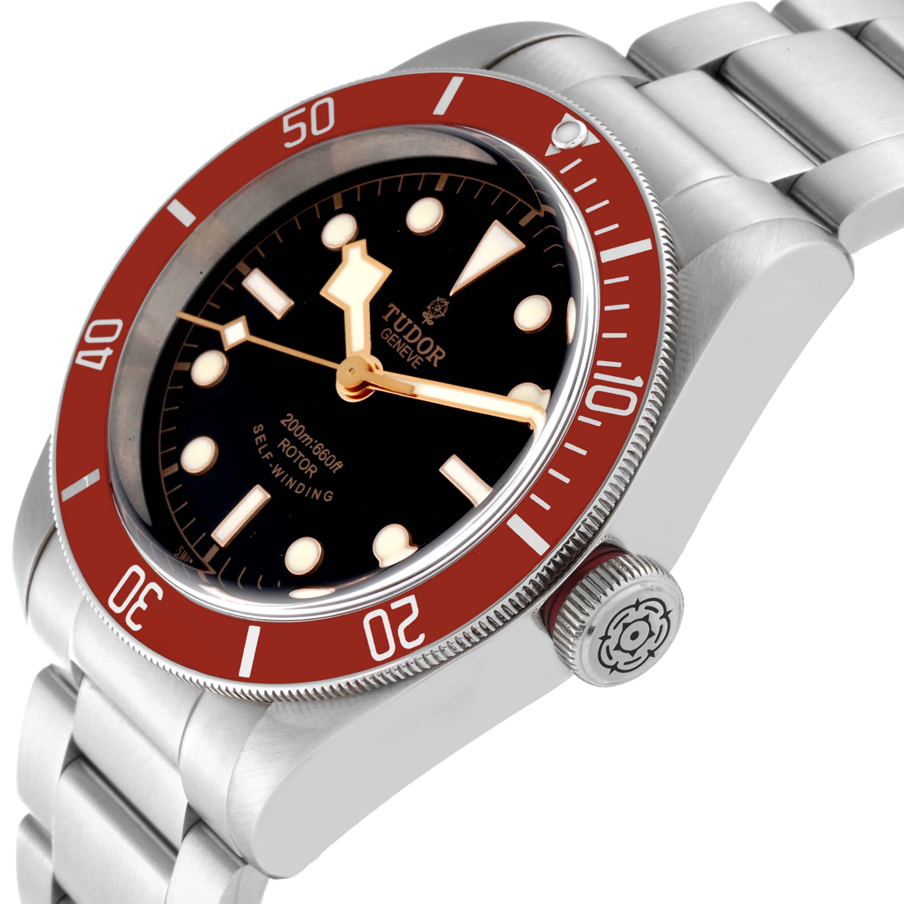 The image shows a side angle of the Tudor Heritage Black Bay 79220R Men
s Stainless Steel Black Dial 79220R Men
s Stainless Steel Black Dial watch, highlighting its dial, bezel, crown, and stainless steel bracelet.