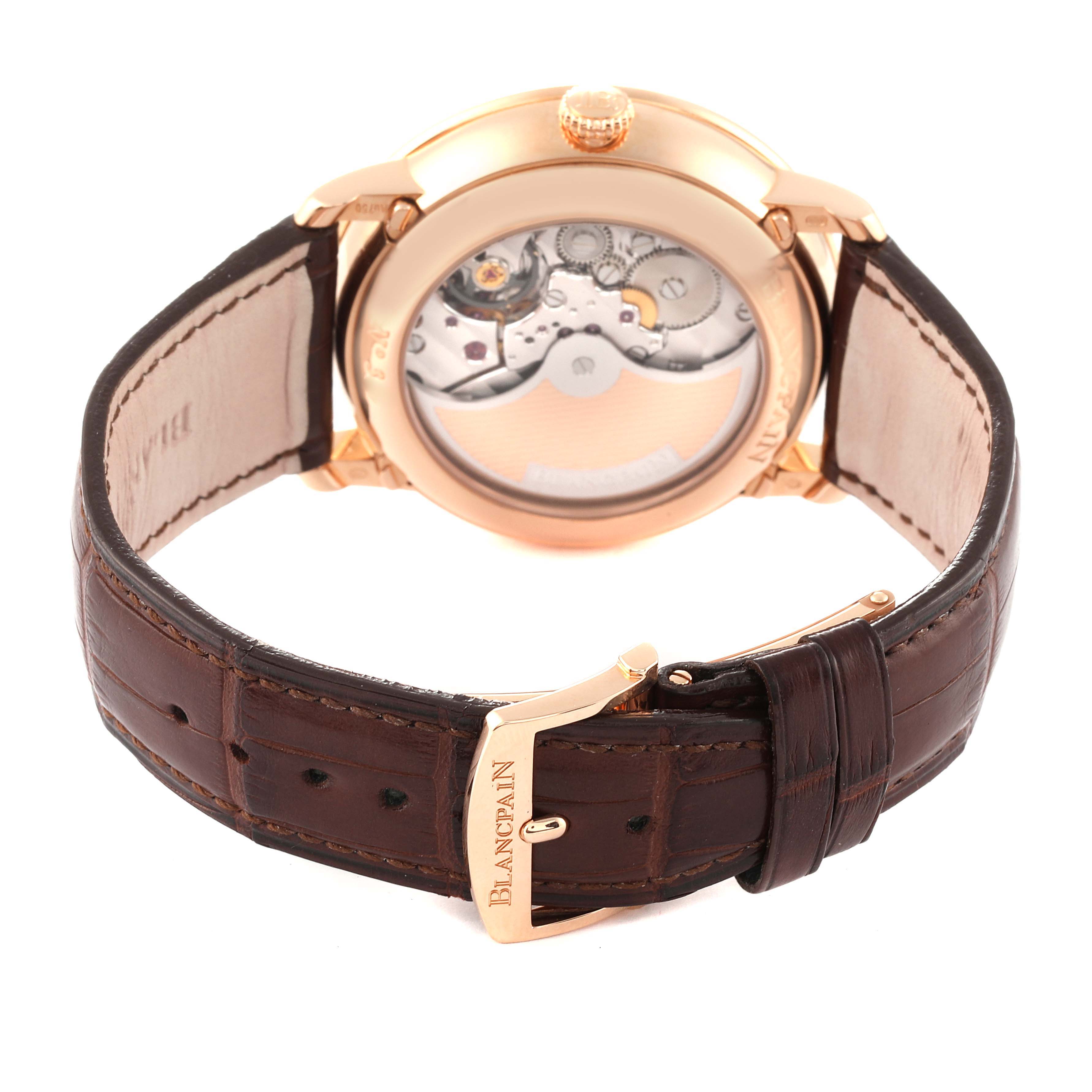 The image shows the back view of a Blancpain Villeret 6639-3642-55B Men's Rose Gold Silver Dial 6639-3642-55B Men's Rose Gold Silver Dial watch, highlighting its open case back and brown leather strap with a buckle.